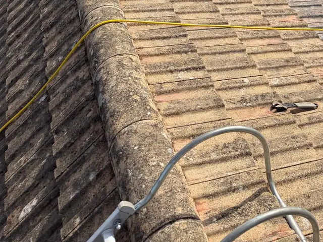 A closer view of the cleaned ridge tiles and the slope beside them.